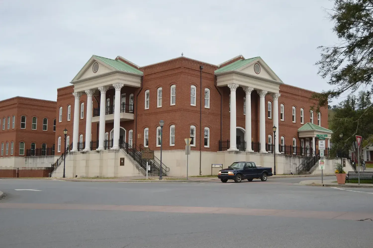 The red-brick Gilmer County Courthouse with its white columned portico, on the square in downtown Ellijay, Georgia